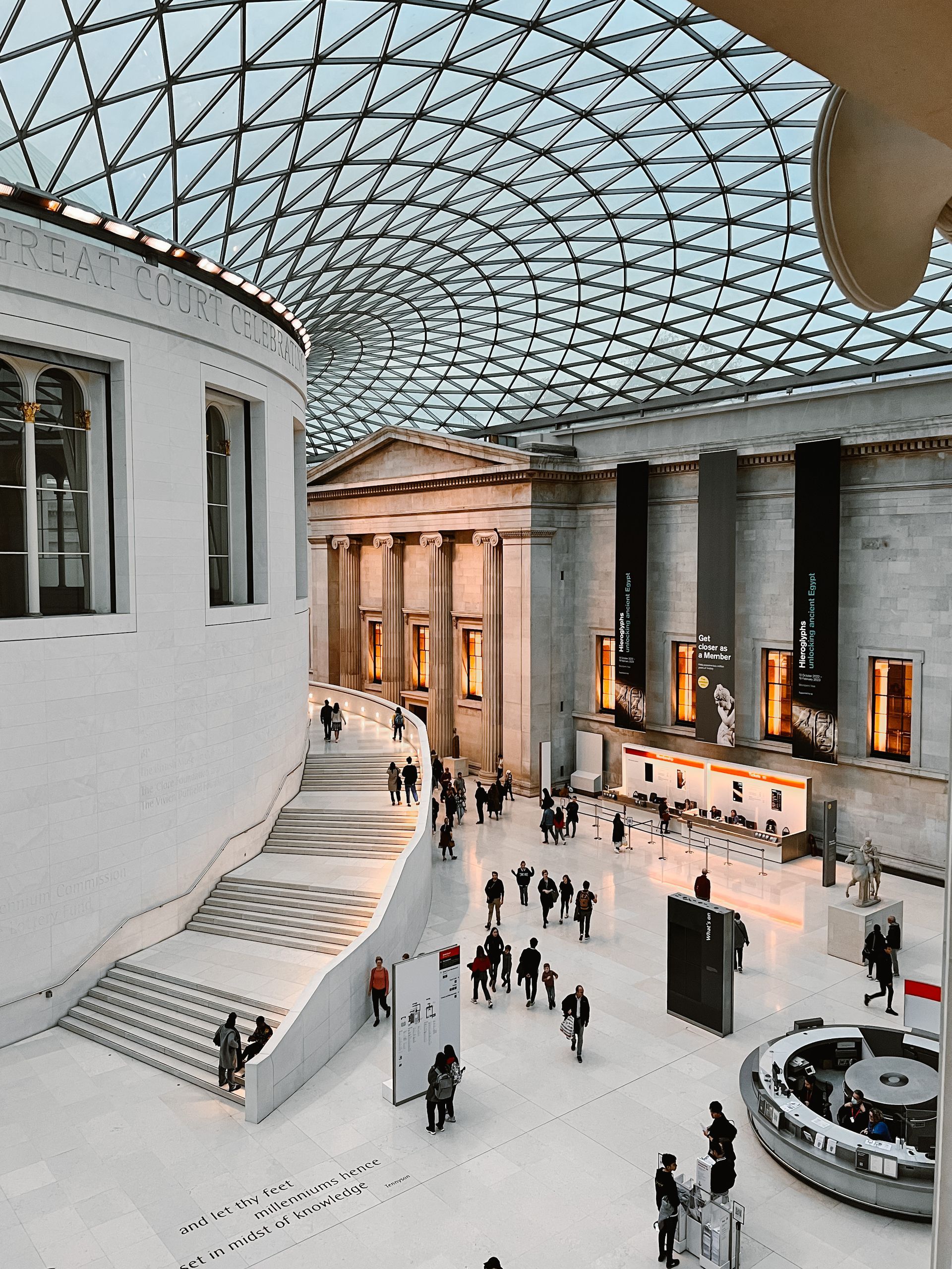 A group of people are walking in a large building