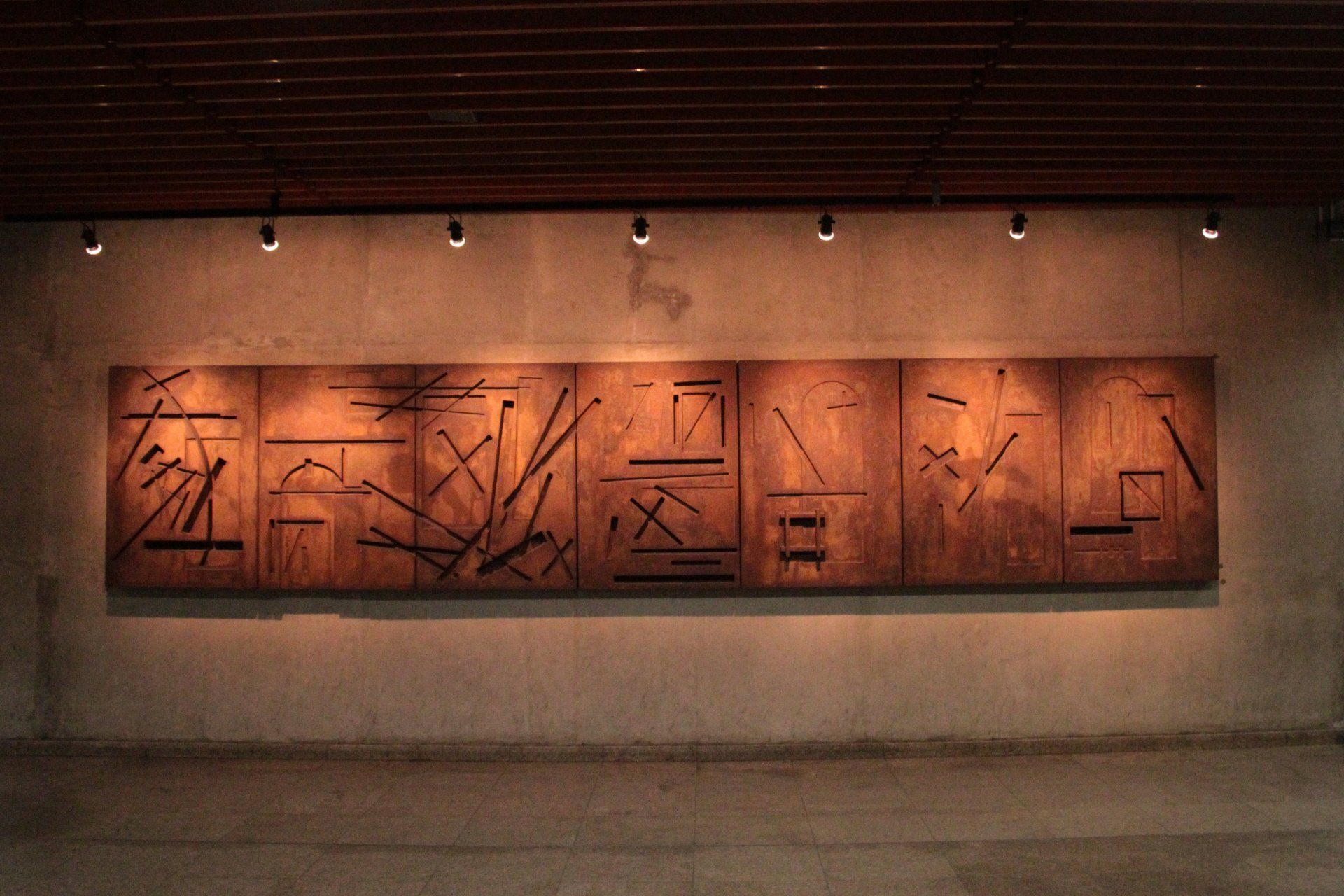 A large painting is hanging on a wall in a room