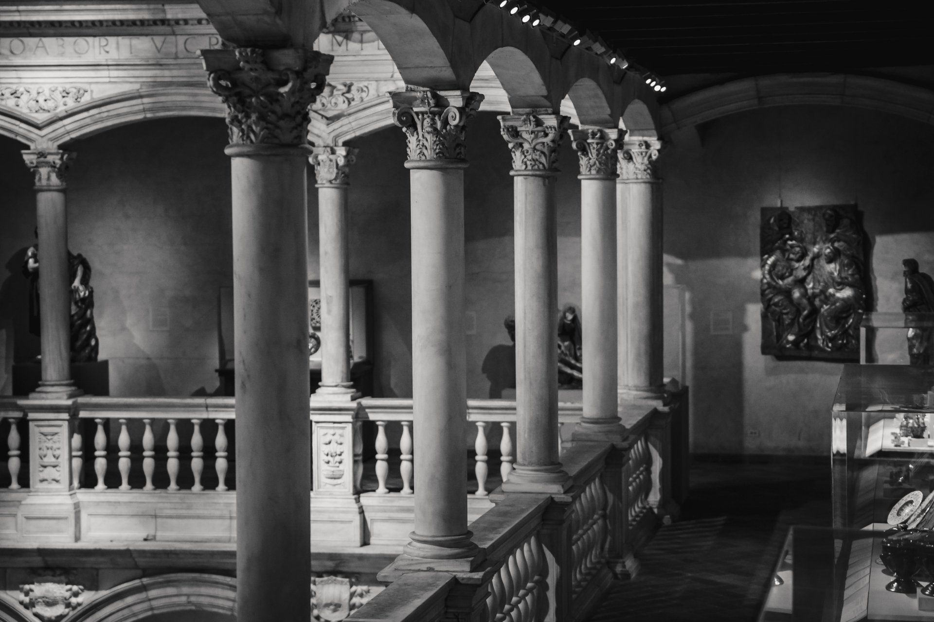 A black and white photo of a building with columns and arches