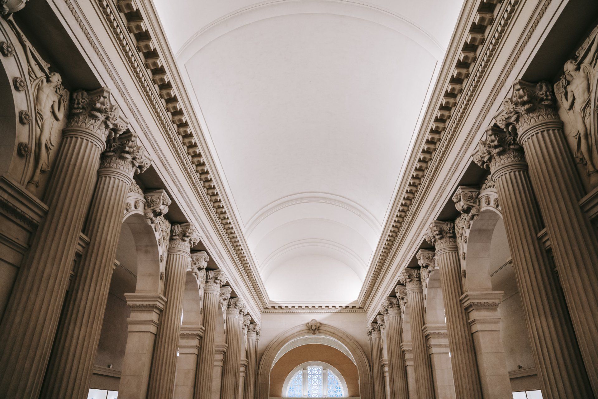 Looking up at the ceiling of a building with columns and arches