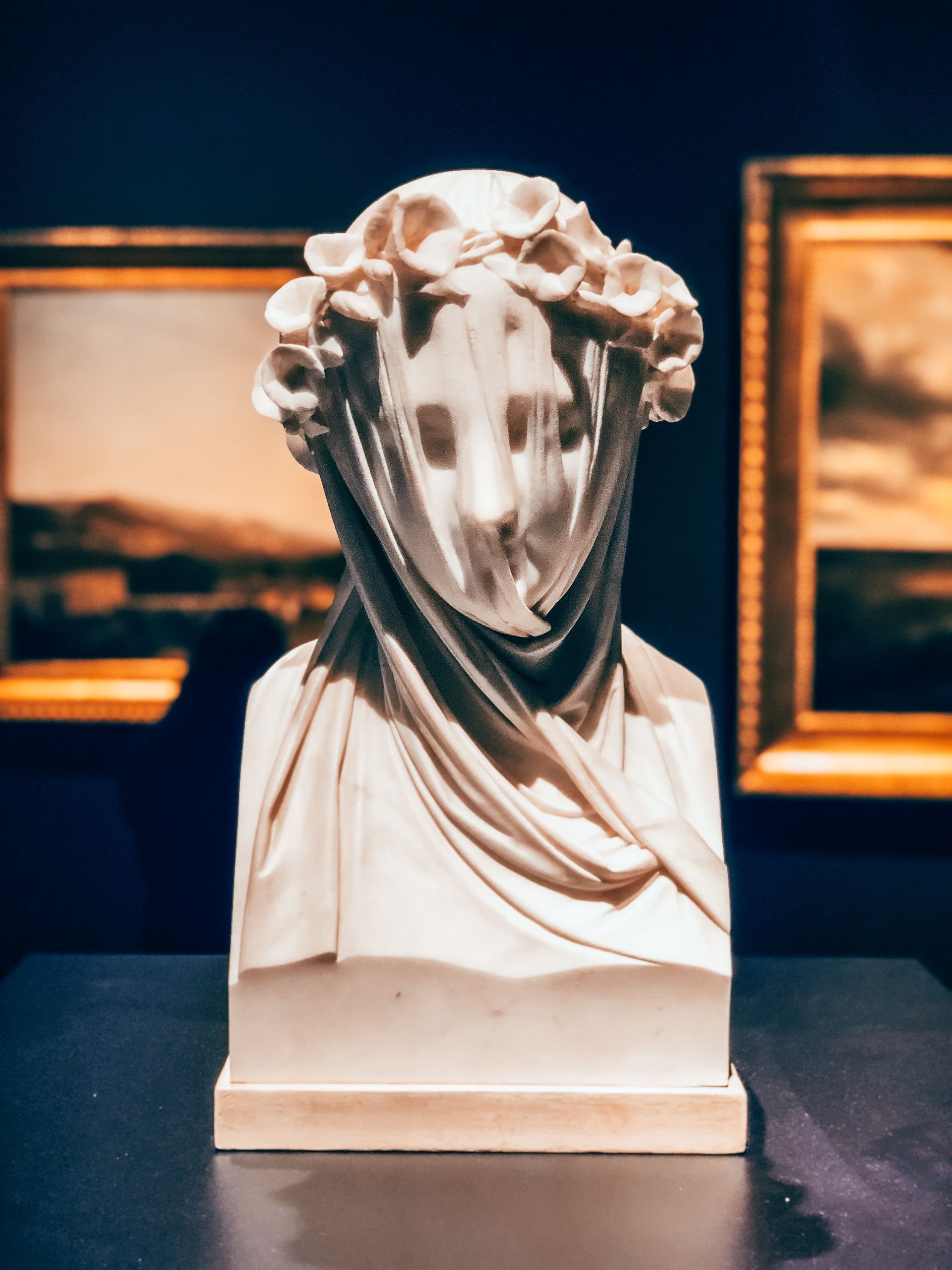 A statue of a woman with a scarf around her head