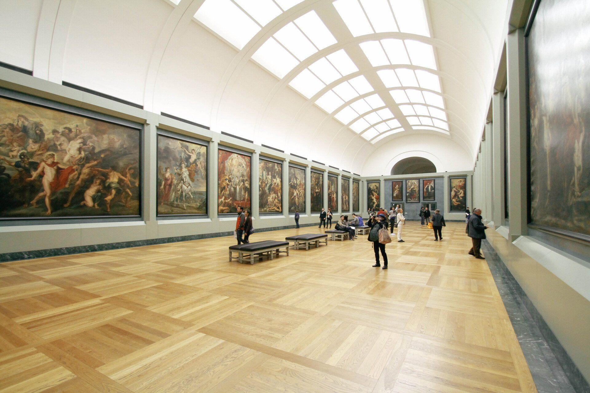 A long hallway in a museum filled with paintings